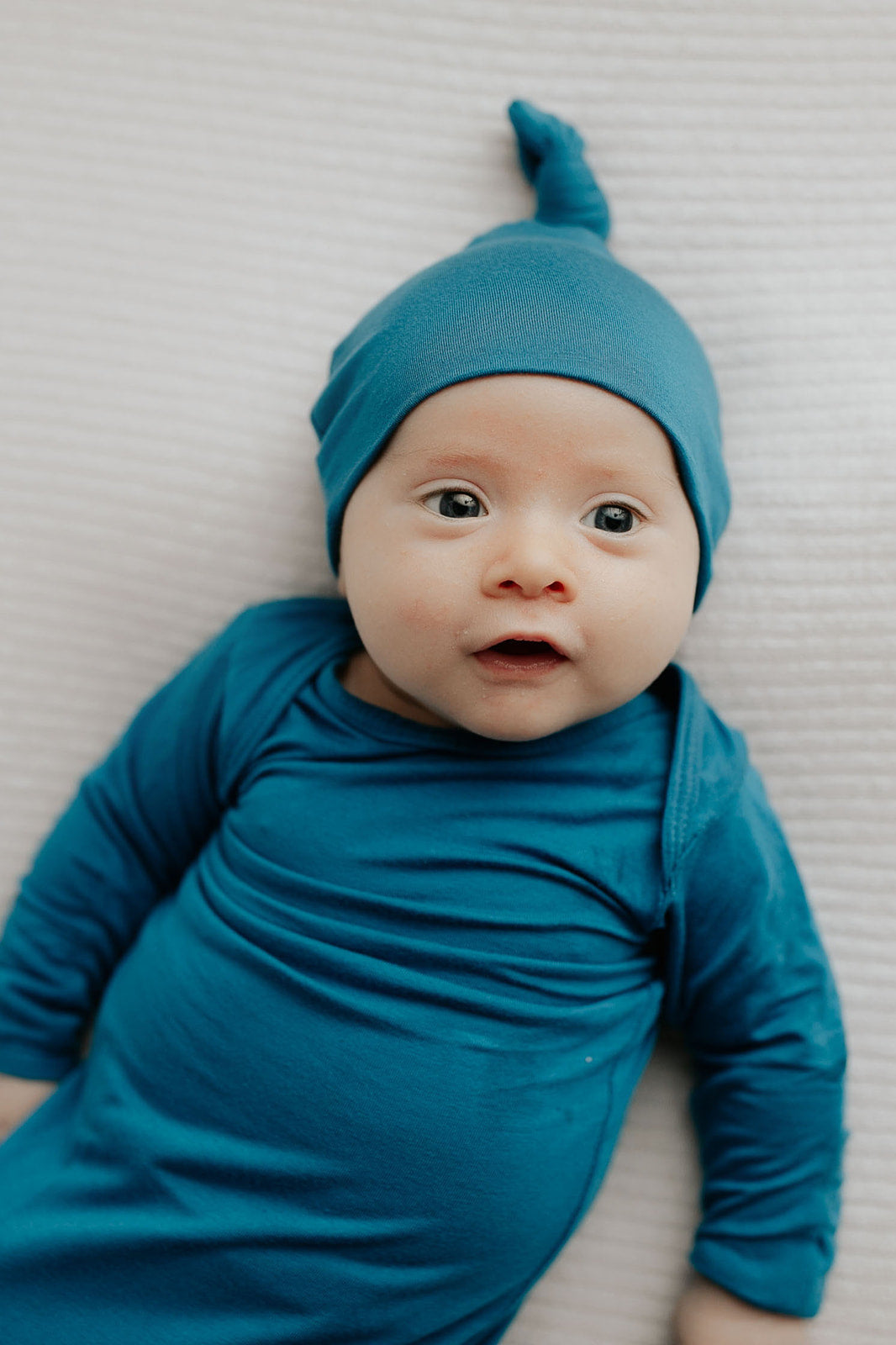 Enhance your newborn photoshoot with cute knotted gowns, perfect for creating heartwarming and memorable baby photos.