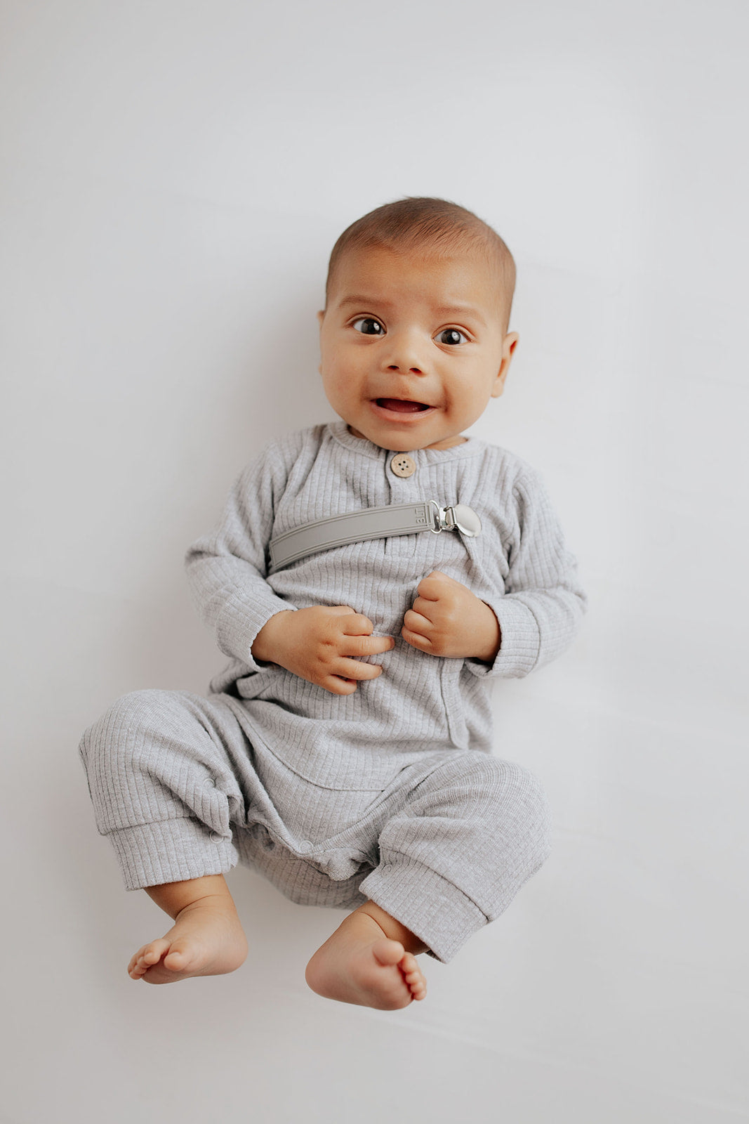 Stylish and functional, our ribbed organic cotton long-sleeve onesie features leg snaps and buttons for easy changes.