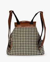 Backpack with houndstooth pattern and brown leather straps on a white background