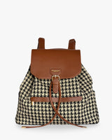 Backpack with houndstooth pattern and brown leather accents on a white background