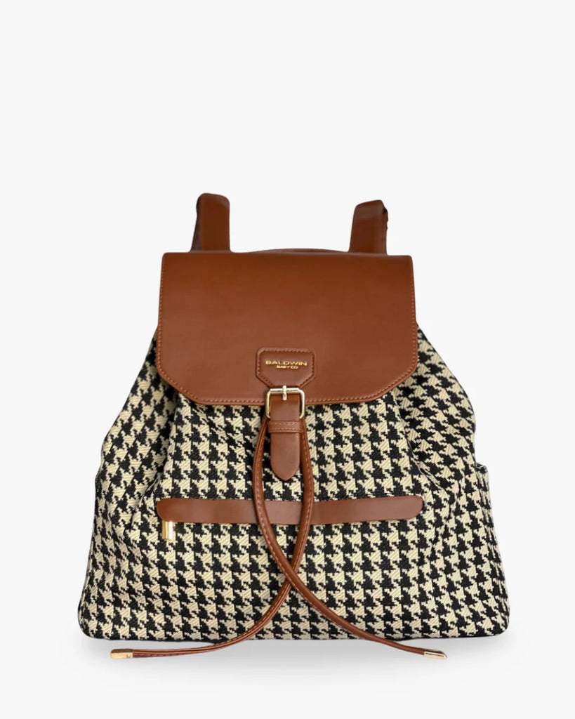 Backpack with houndstooth pattern and brown leather accents on a white background