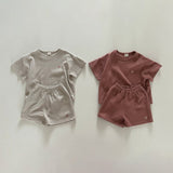 Two children's clothing sets, one gray and one brown, on a light gray background.
