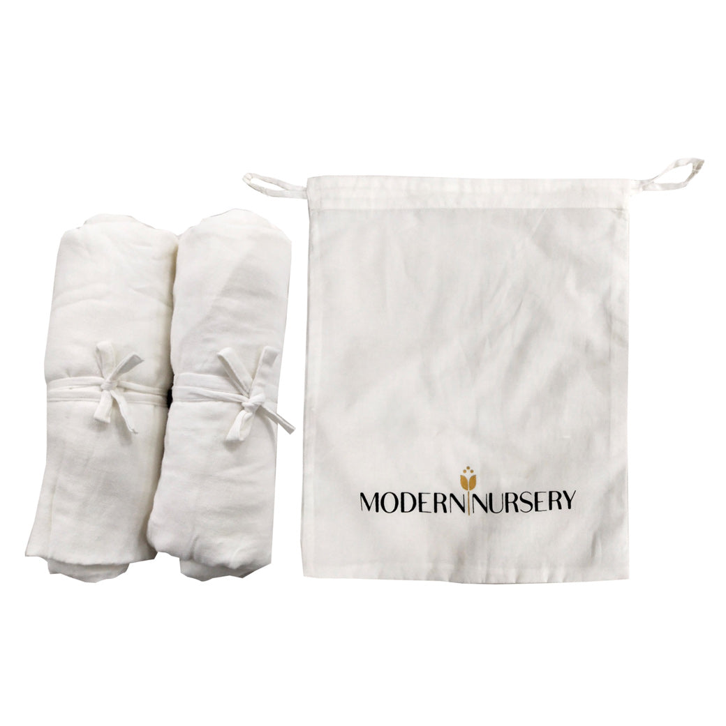 Three Little Tots Organic Muslin Crib Sheets Set of 2, attached to a car seat or stroller