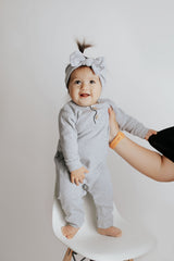 Stylish and functional, our ribbed organic cotton long-sleeve onesie features leg snaps and buttons for easy changes.