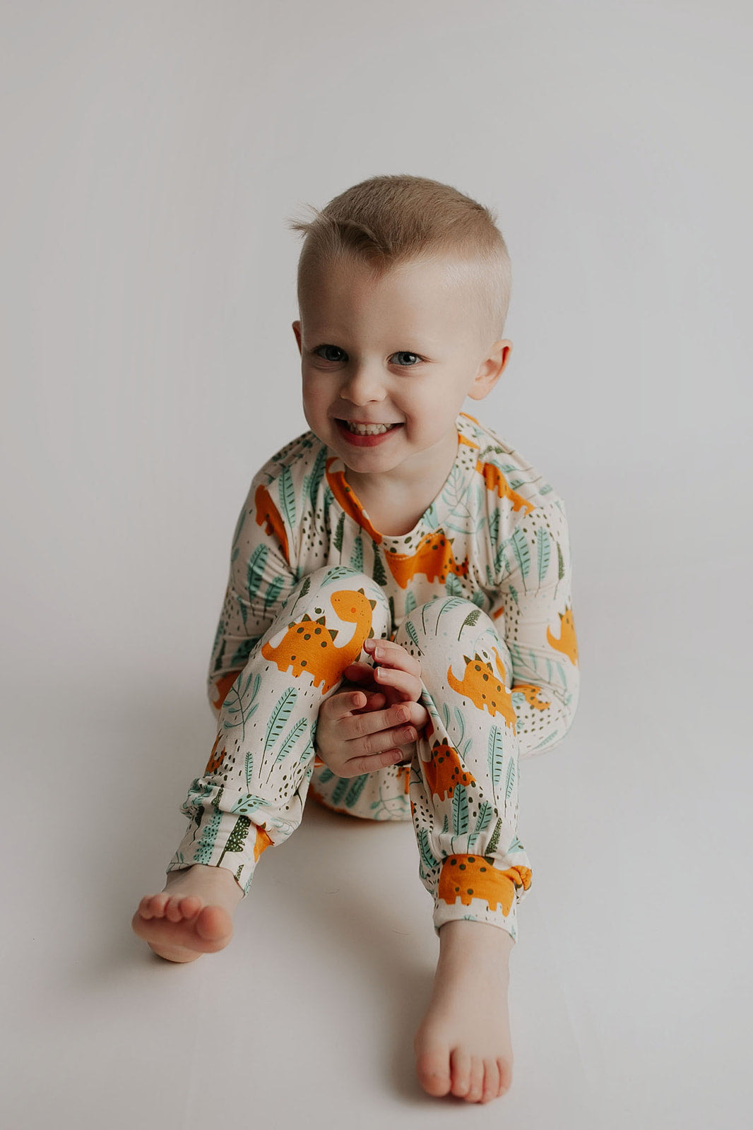 Toddler and big kid jammies in matching prints and solids, designed for comfy bedtime or lounging all day. Dinosaur themed Kids Pajamas.