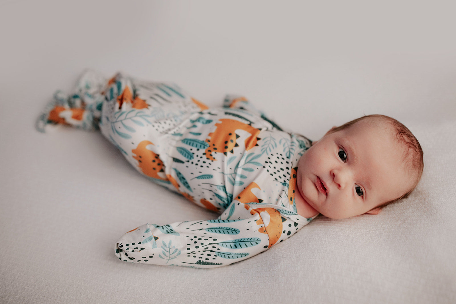 Ultra-soft Dinosaur baby gowns with stretchy fabric and tie bottom for easy night-time diaper changes.