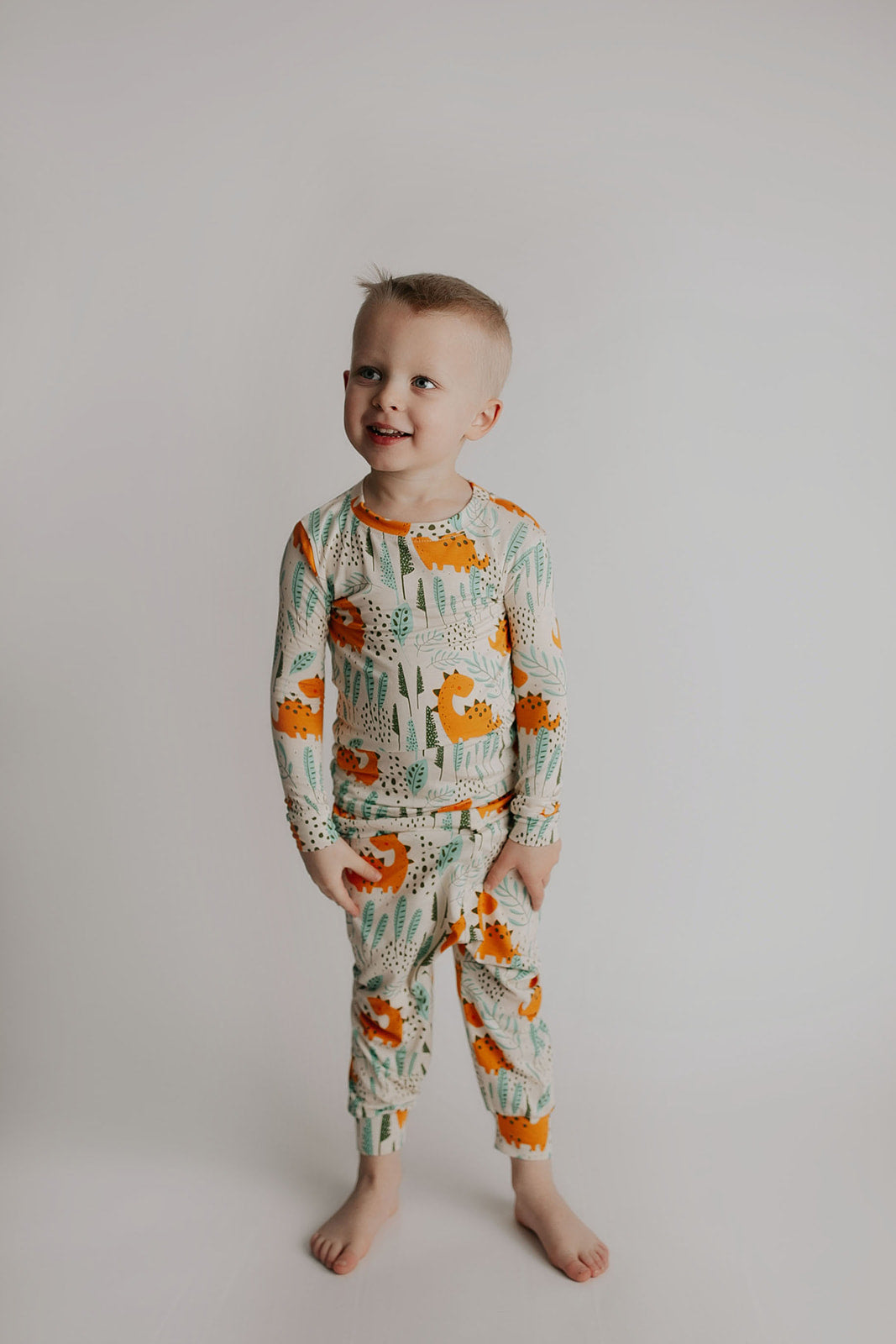 Toddler and big kid jammies in matching prints and solids, designed for comfy bedtime or lounging all day. Dinosaur themed Kids Pajamas.