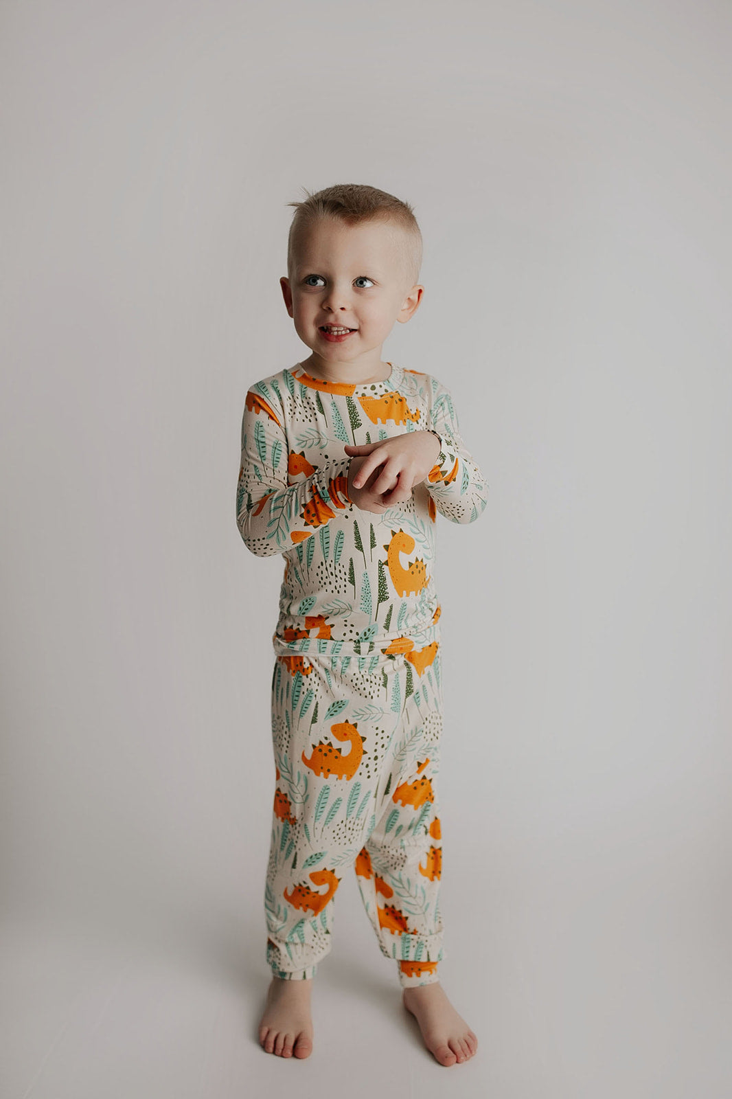 Toddler and big kid jammies in matching prints and solids, designed for comfy bedtime or lounging all day. Dinosaur themed Kids Pajamas.