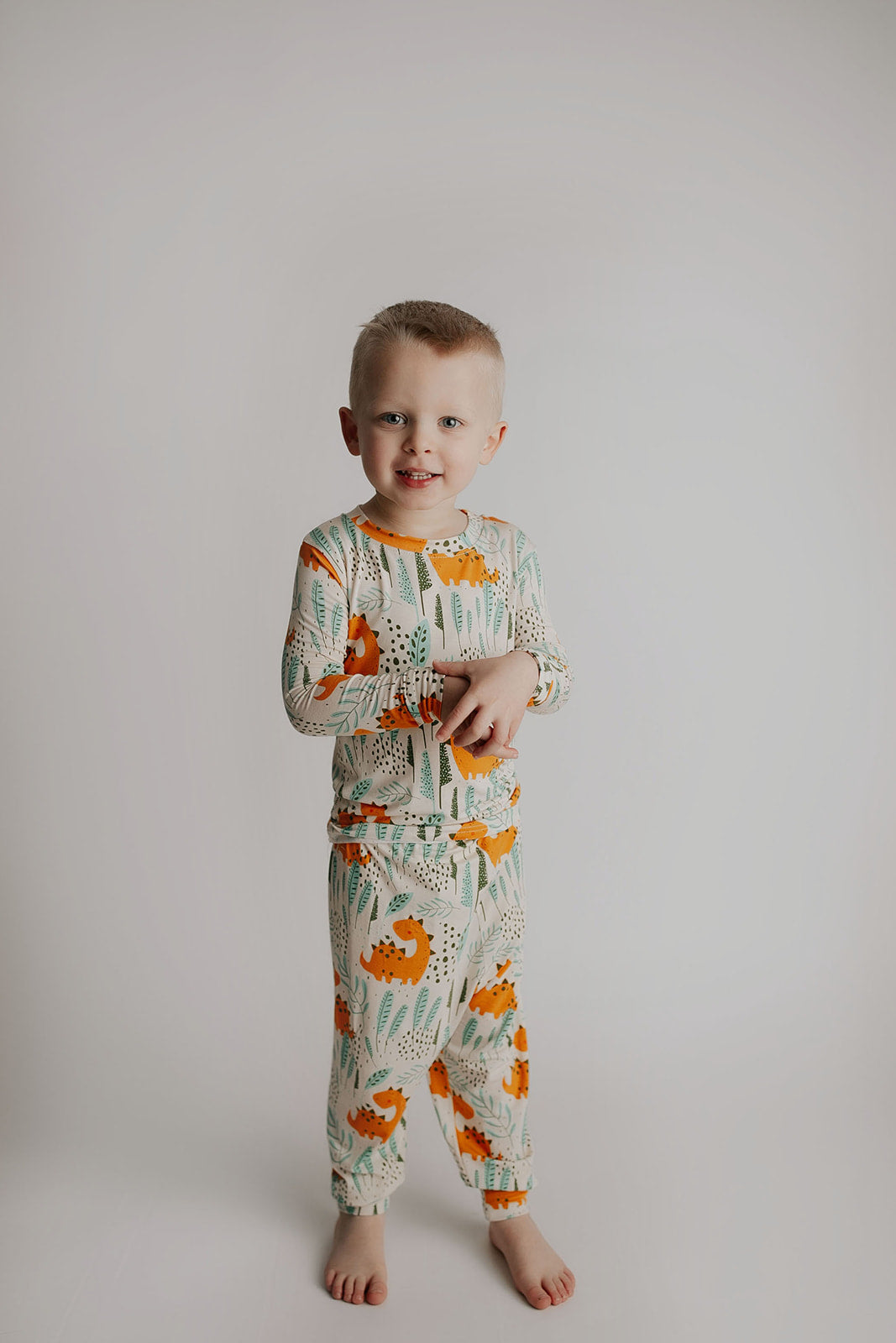 Toddler and big kid jammies in matching prints and solids, designed for comfy bedtime or lounging all day. Dinosaur themed Kids Pajamas.