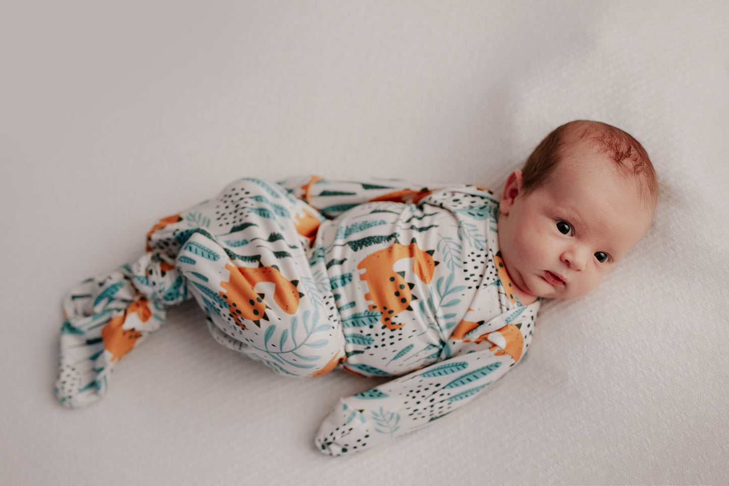 Ultra-soft Dinosaur baby gowns with stretchy fabric and tie bottom for easy night-time diaper changes.