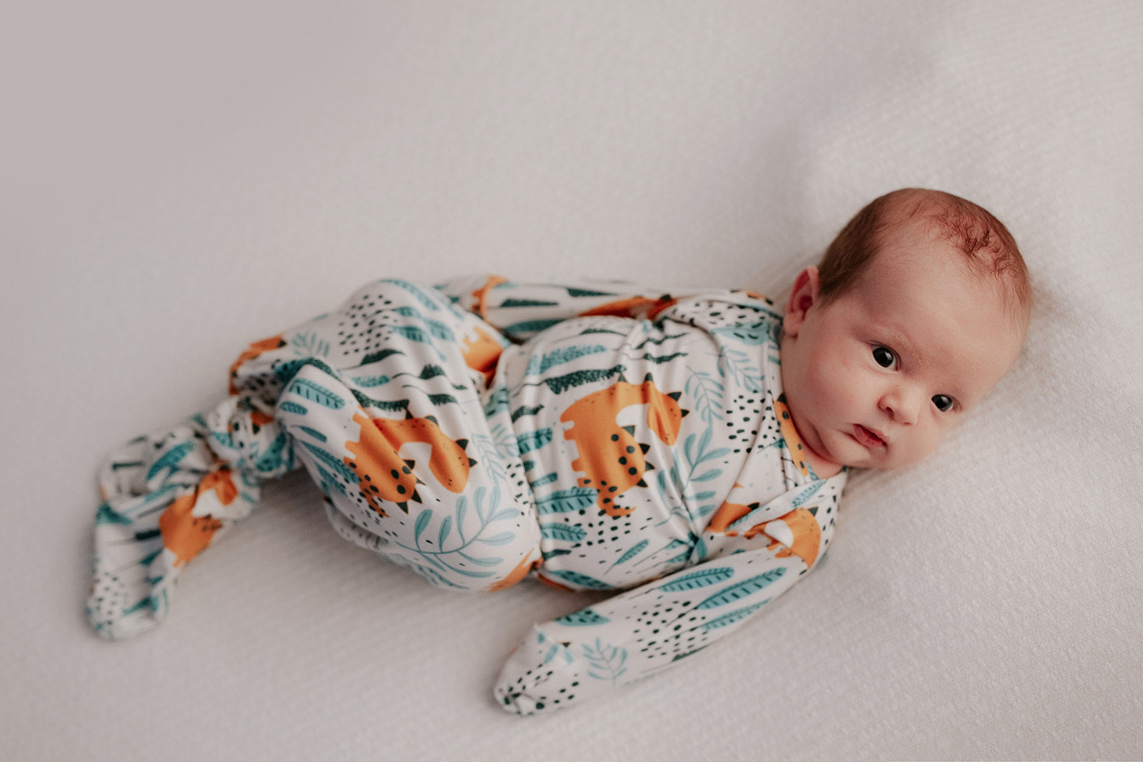Ultra-soft Dinosaur baby gowns with stretchy fabric and tie bottom for easy night-time diaper changes.