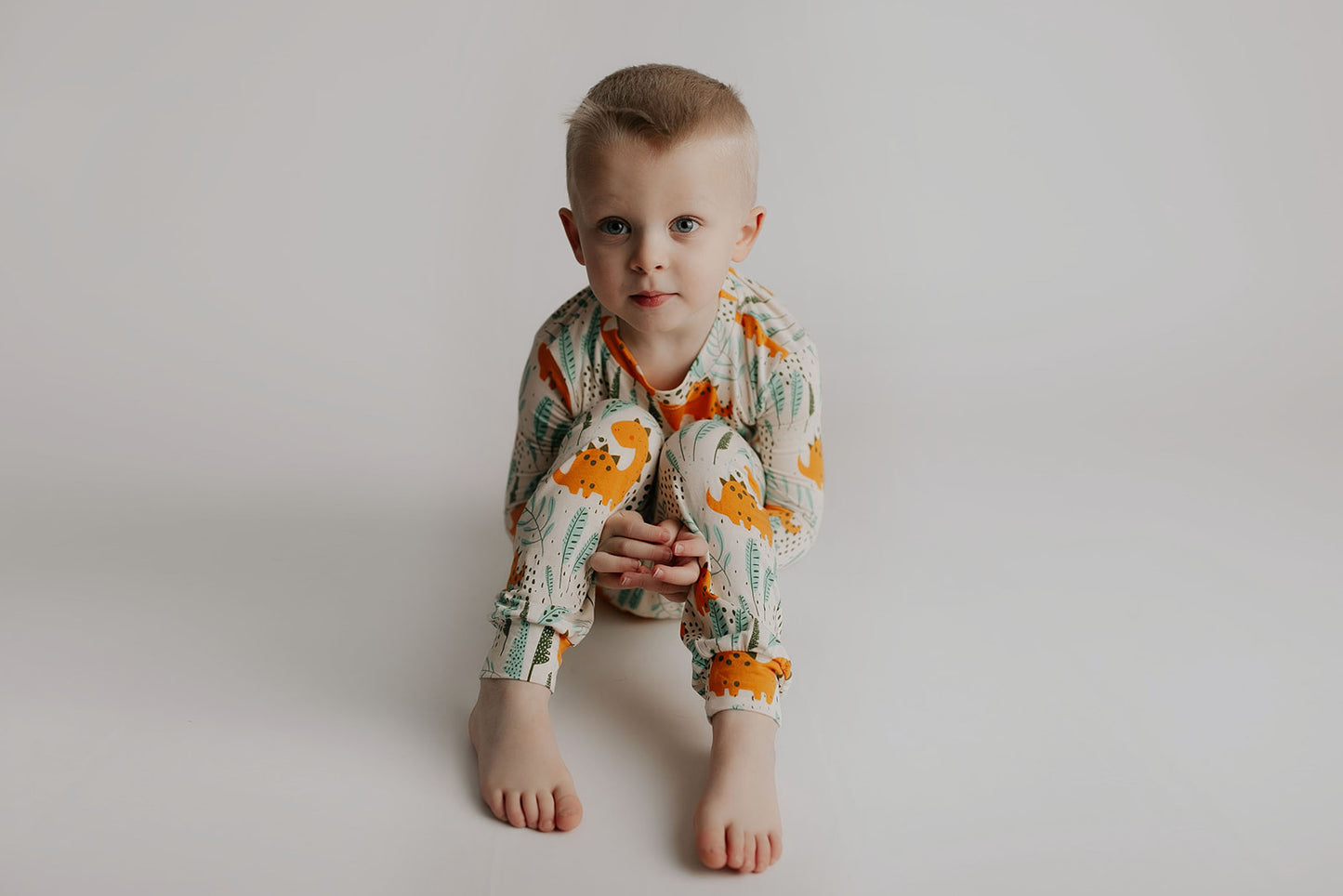 Toddler and big kid jammies in matching prints and solids, designed for comfy bedtime or lounging all day. Dinosaur themed Kids Pajamas.