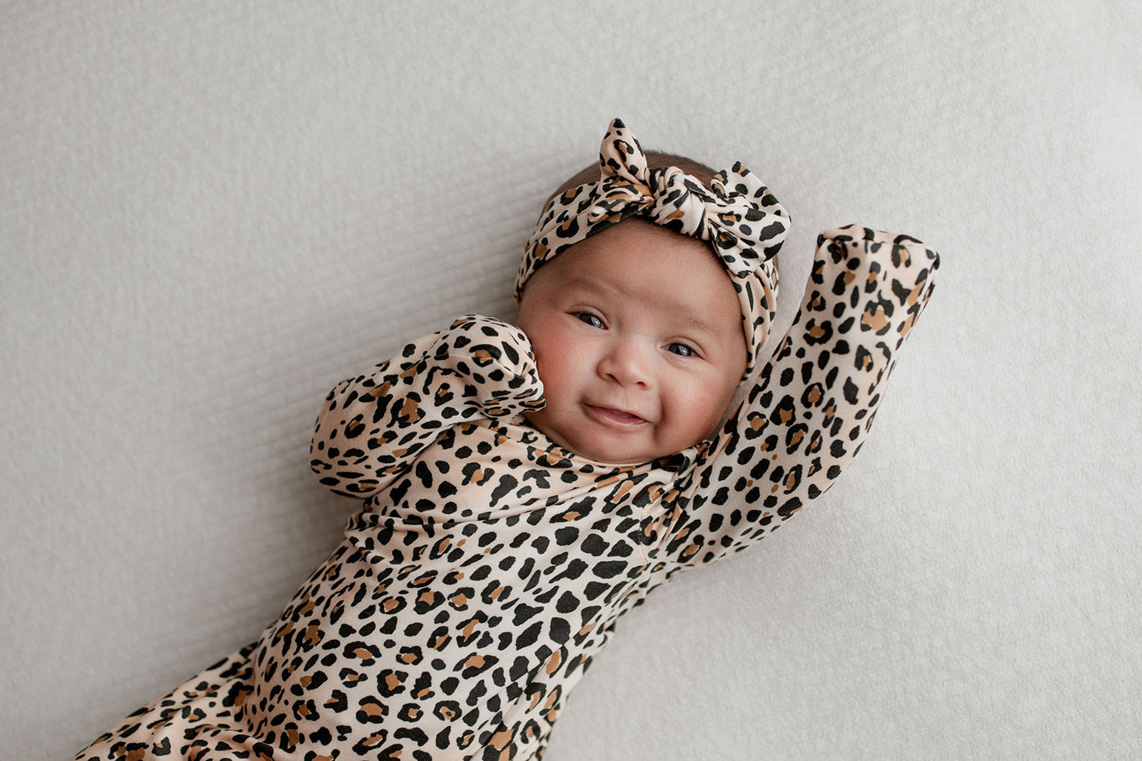Three Little Tots Knotted baby gown features fold over mittens and a tie bottom that mimics the womb to bring comfort to newborns.
