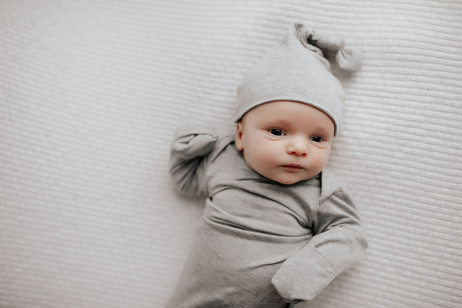 newborn baby boy in a Three Little Tots knotted baby gown