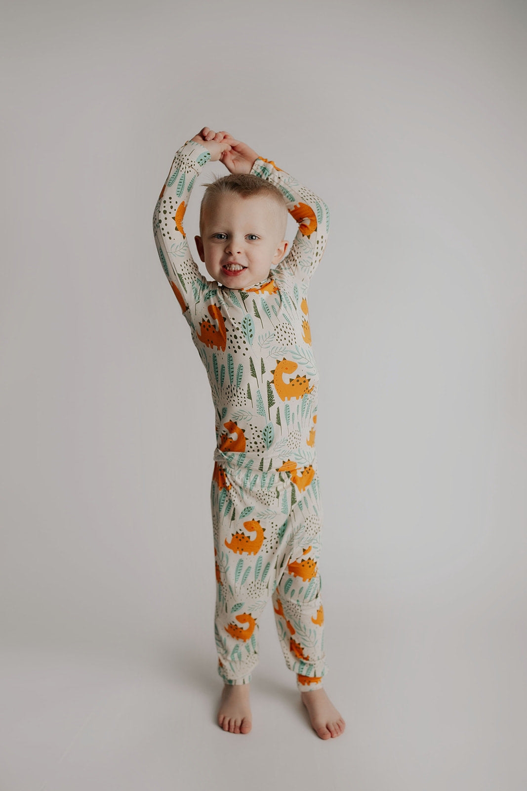 Toddler and big kid jammies in matching prints and solids, designed for comfy bedtime or lounging all day. Dinosaur themed Kids Pajamas.