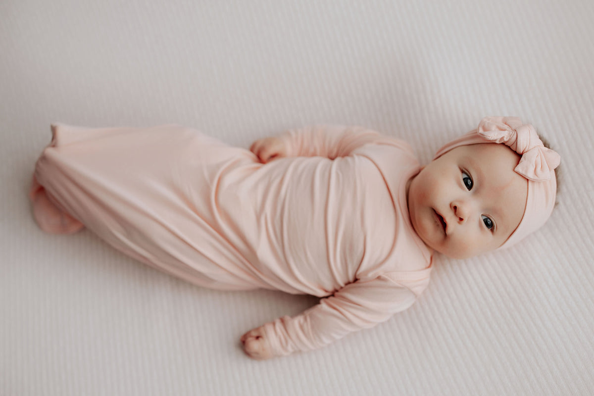 precious photo of newborn baby in the Three Little Tots Heavenly Pink knotted baby gown