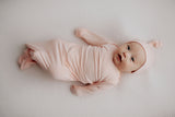 adorable newborn baby girl photoshoot in a Three Little Tots heavenly Pink knotted baby gown