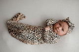 A newborn photoshoot idea with the Leopard Three Little Tots knotted baby gown with a cute bow.