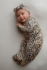 A newborn photoshoot idea with the Leopard Three Little Tots knotted baby gown with a cute bow.