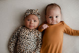 Three Little Tots Knotted baby gown features fold over mittens and a tie bottom that mimics the womb to bring comfort to newborns.