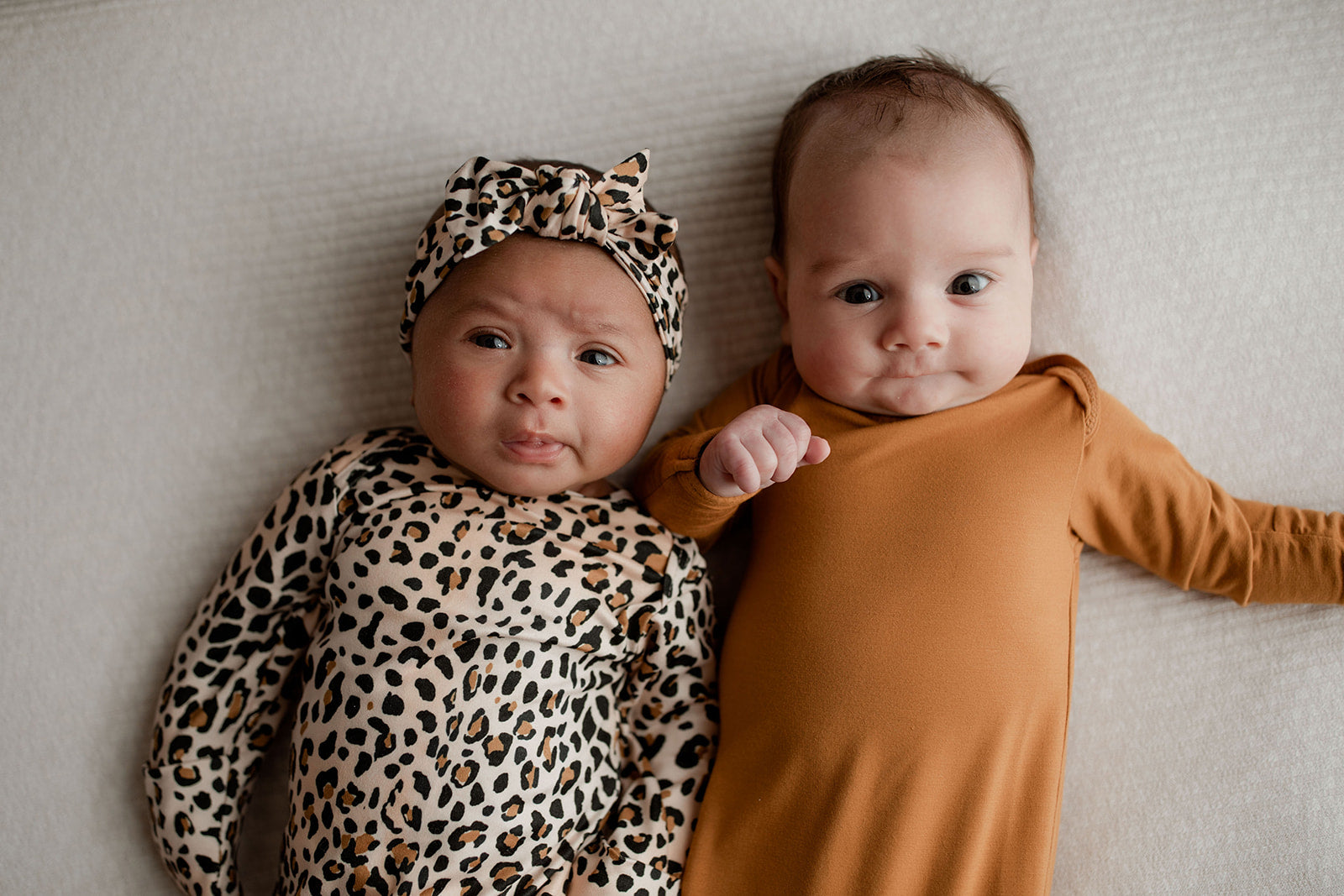 Three Little Tots Knotted baby gown features fold over mittens and a tie bottom that mimics the womb to bring comfort to newborns.