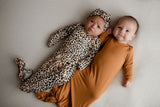 Three Little Tots Knotted baby gown features fold over mittens and a tie bottom that mimics the womb to bring comfort to newborns.