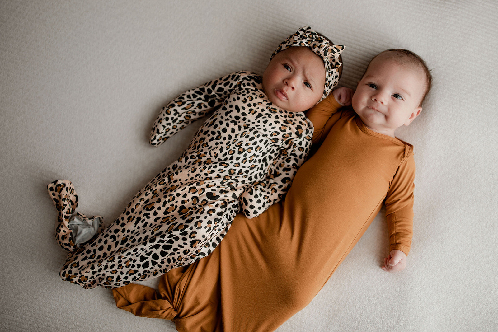 Three Little Tots Knotted baby gown features fold over mittens and a tie bottom that mimics the womb to bring comfort to newborns.