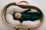 Ultra-soft baby gowns with tie bottoms for easy nighttime changes and pull-down tabs for effortless dressing. Perfect for a Christmas baby. Plum + Sparrow Moses basket