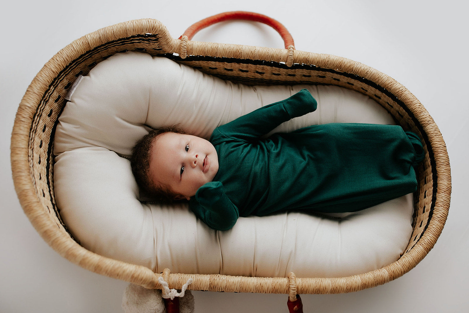 Ultra-soft baby gowns with tie bottoms for easy nighttime changes and pull-down tabs for effortless dressing. Perfect for a Christmas baby. Plum + Sparrow Moses basket