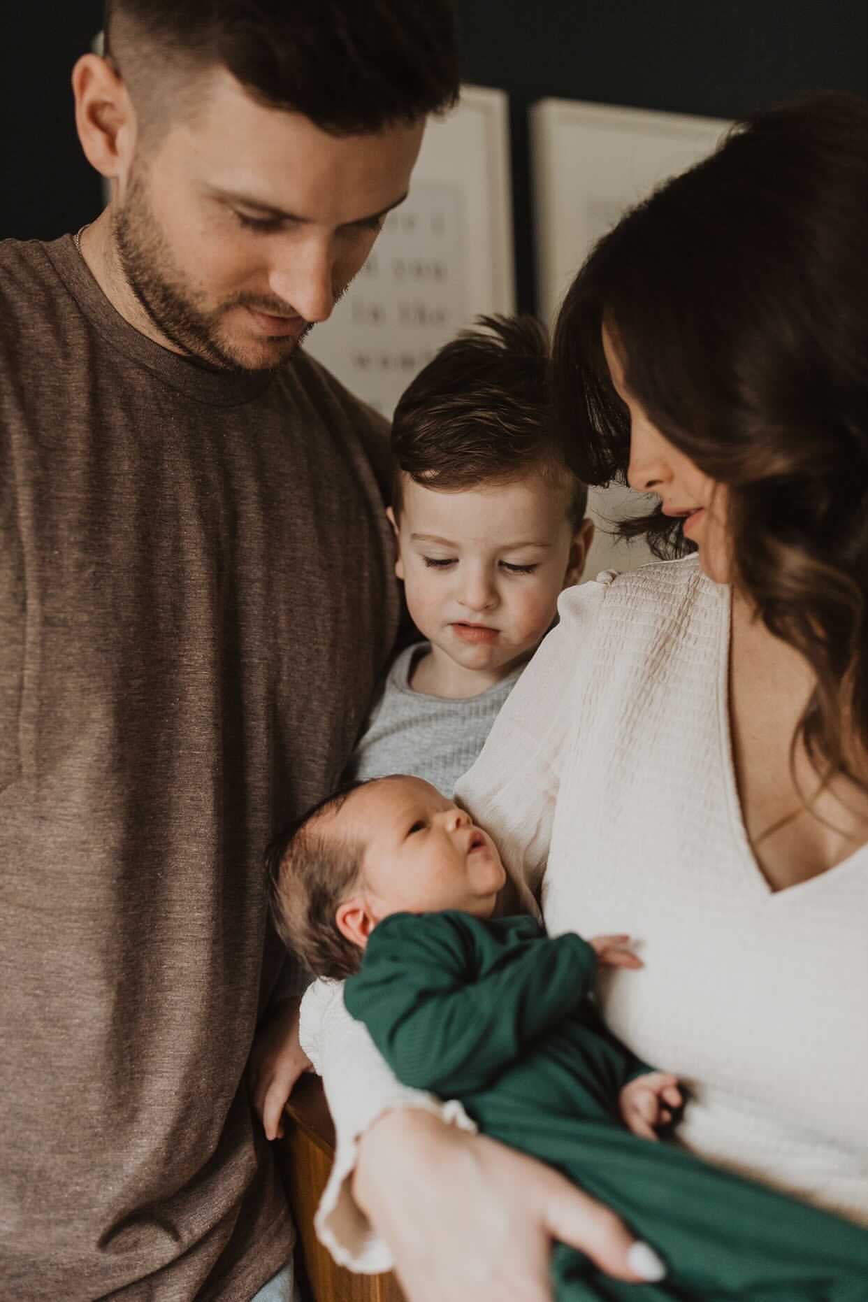 Newborn family photoshoot. Baby is wearing Three Little Tots Forest Green Knotted Gown