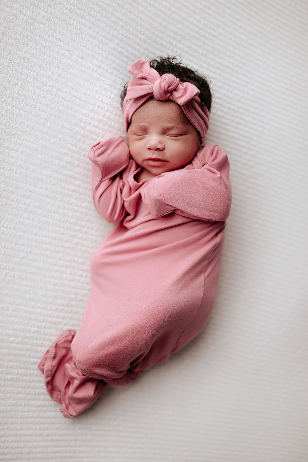 Luxuriously soft modal knotted baby gowns for newborn babies, offering comfort, easy diaper changes, and style. Three Little Tots Rose Pink Knotted baby gown. Knotted tie bottom mimics the womb to bring comfort to your newborn