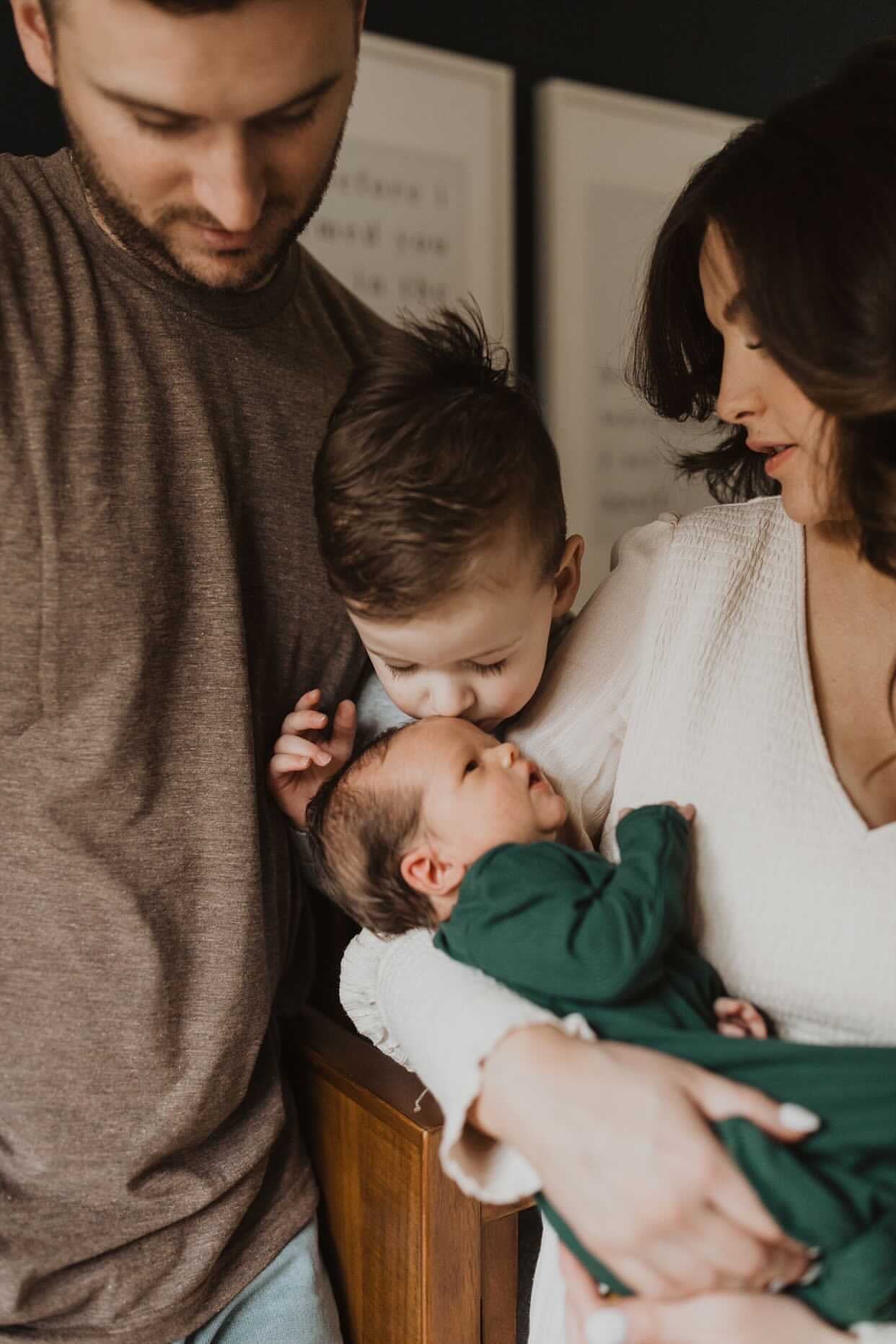 Newborn family photoshoot. Baby is wearing Three Little Tots Forest Green Knotted Gown