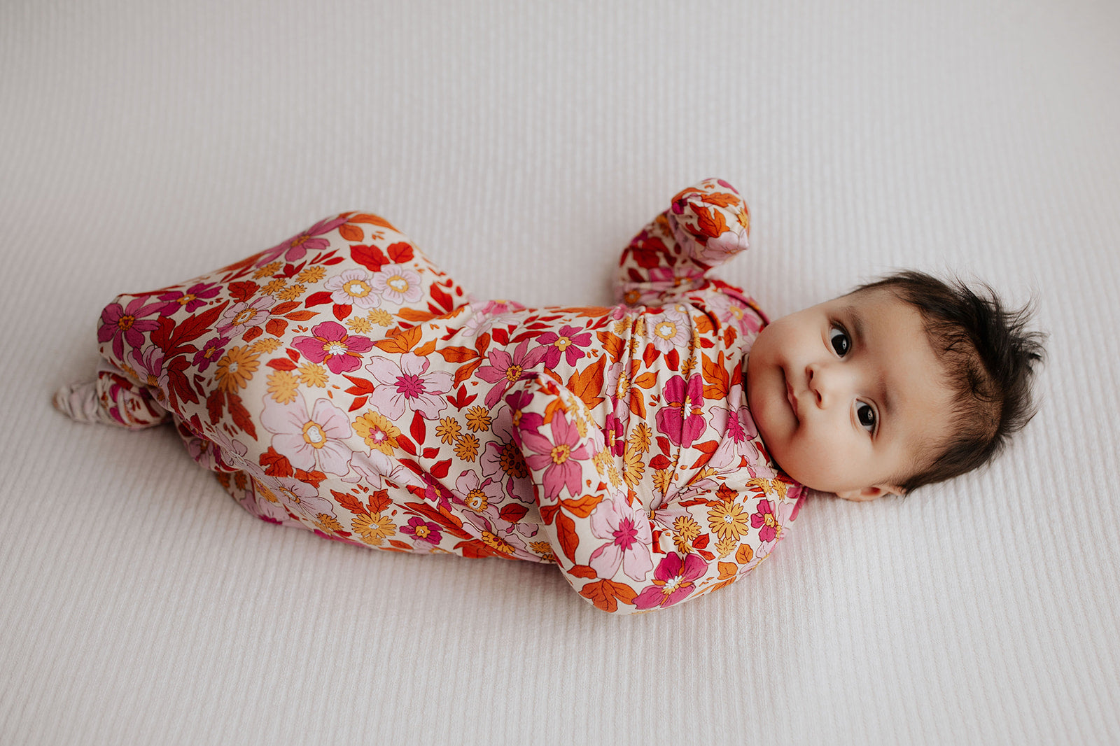 The cutest pink floral design for a newborn knotted baby gown. Trust in our knotted baby gowns, providing unparalleled comfort and ease for your baby's delicate skin.