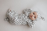 newborn baby in a Three Little Tots polka dot knotted baby gown