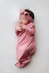 little girl knotted baby gown in rose pink newborn photoshoot