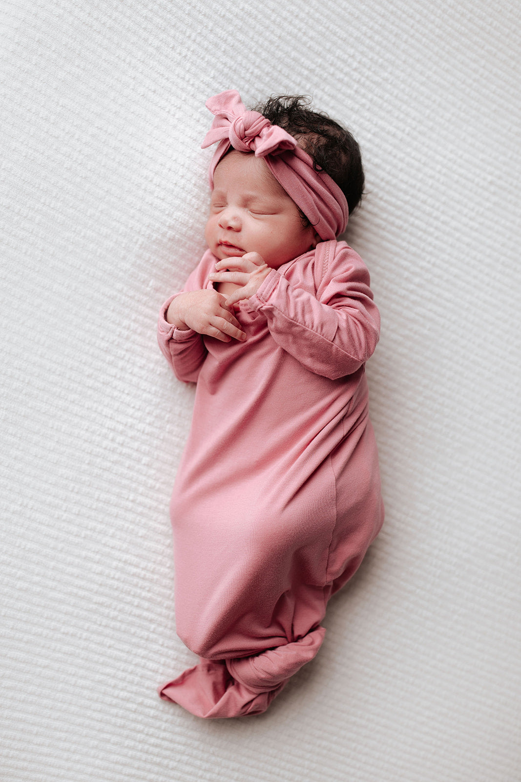 little girl knotted baby gown in rose pink newborn photoshoot
