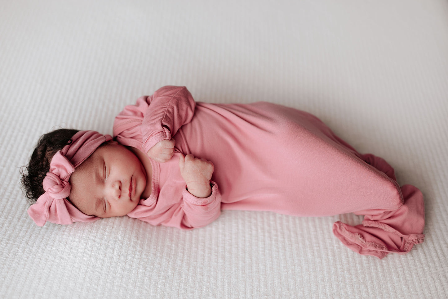 Luxuriously soft modal knotted baby gowns for newborn babies, offering comfort, easy diaper changes, and style. Three Little Tots Rose Pink Knotted baby gown. Knotted tie bottom mimics the womb to bring comfort to your newborn