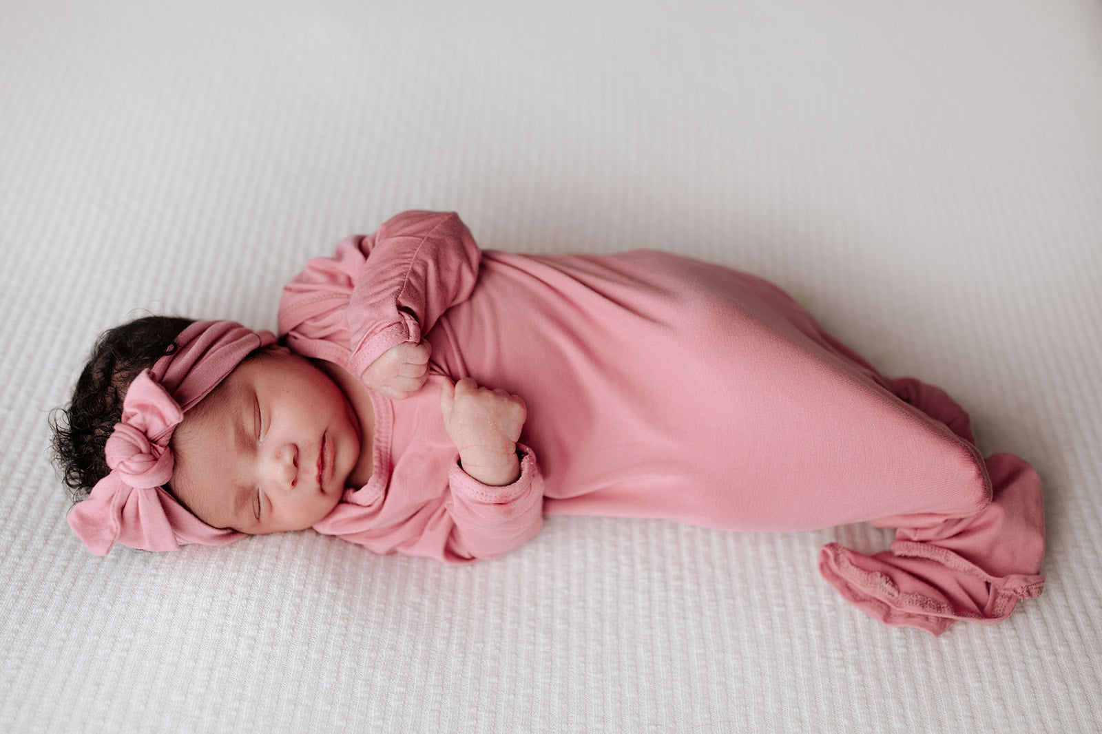 Luxuriously soft modal knotted baby gowns for newborn babies, offering comfort, easy diaper changes, and style. Three Little Tots Rose Pink Knotted baby gown. Knotted tie bottom mimics the womb to bring comfort to your newborn