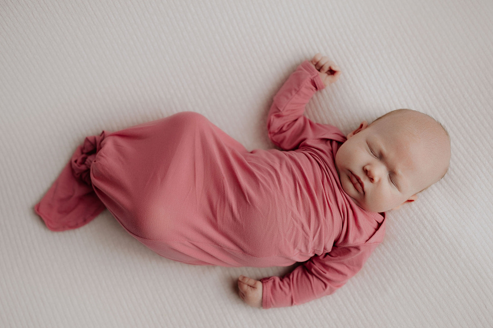 Luxuriously soft modal knotted baby gowns for newborn babies, offering comfort, easy diaper changes, and style. Three Little Tots Rose Pink Knotted baby gown. 