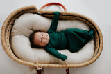 Ultra-soft baby gowns with tie bottoms for easy nighttime changes and pull-down tabs for effortless dressing. Perfect for a Christmas baby. Shown in a SnuggleMe organics in a Plum + Sparrow Moses Basket