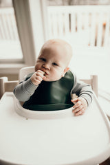 Designed in the USA, Three Little Tots food-grade silicone bibs with crumb catcher ensure comfort and cleanliness for your baby.