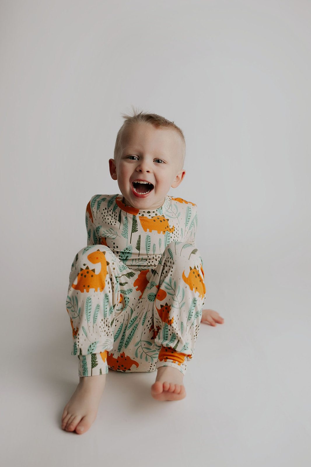 Toddler and big kid jammies in matching prints and solids, designed for comfy bedtime or lounging all day. Dinosaur themed Kids Pajamas.