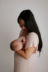 Mom nursing using the Three Little Tots labor and delivery gown