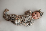 Three Little Tots Knotted baby gown features fold over mittens and a tie bottom that mimics the womb to bring comfort to newborns.