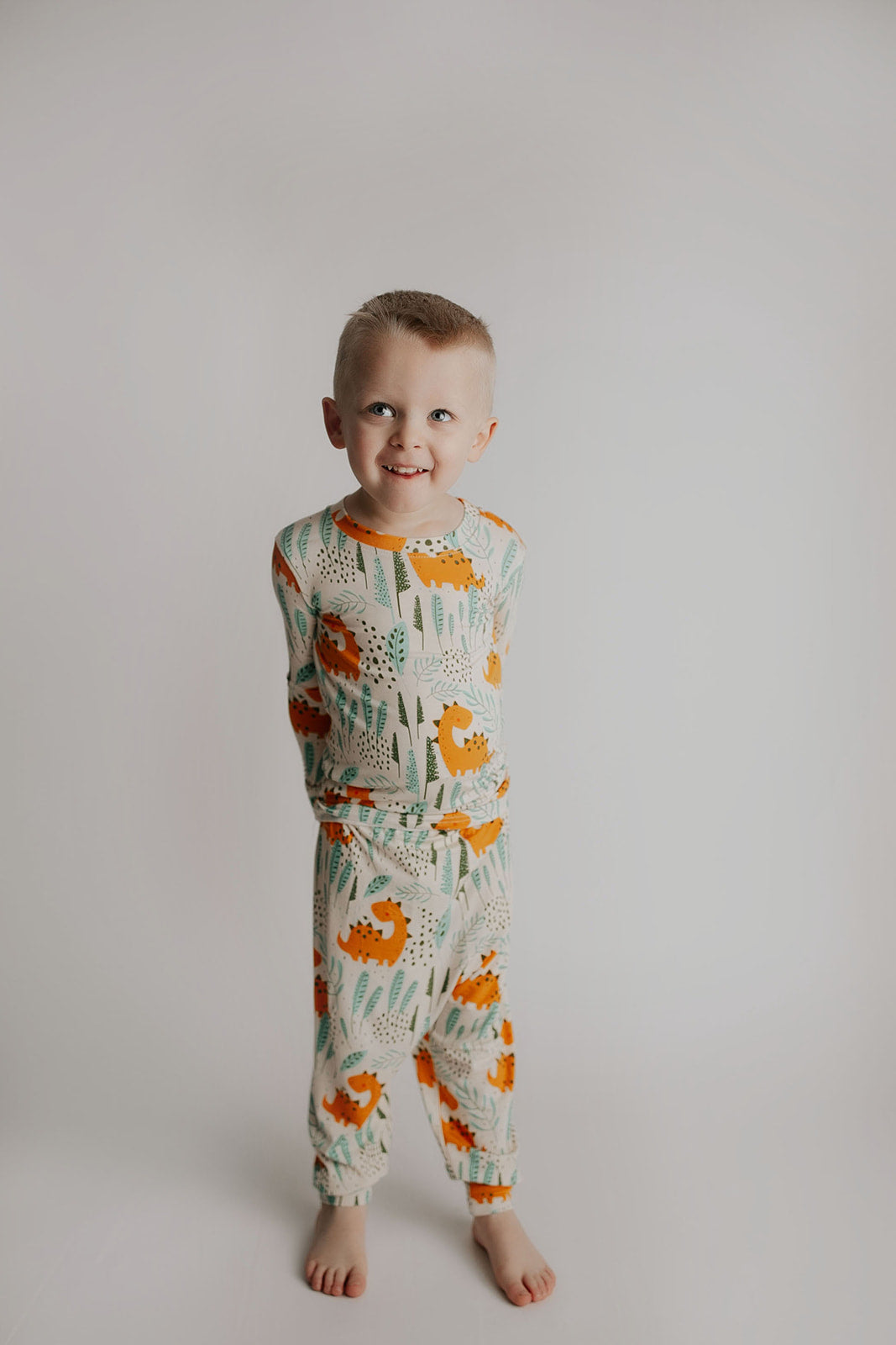 Toddler and big kid jammies in matching prints and solids, designed for comfy bedtime or lounging all day. Dinosaur themed Kids Pajamas.