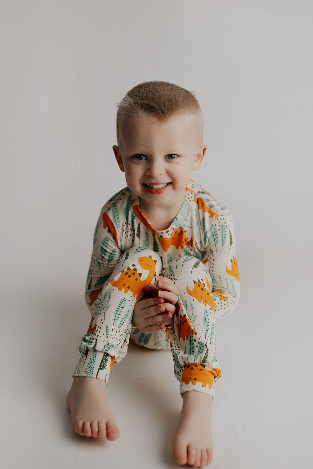 Toddler and big kid jammies in matching prints and solids, designed for comfy bedtime or lounging all day. Dinosaur themed Kids Pajamas.