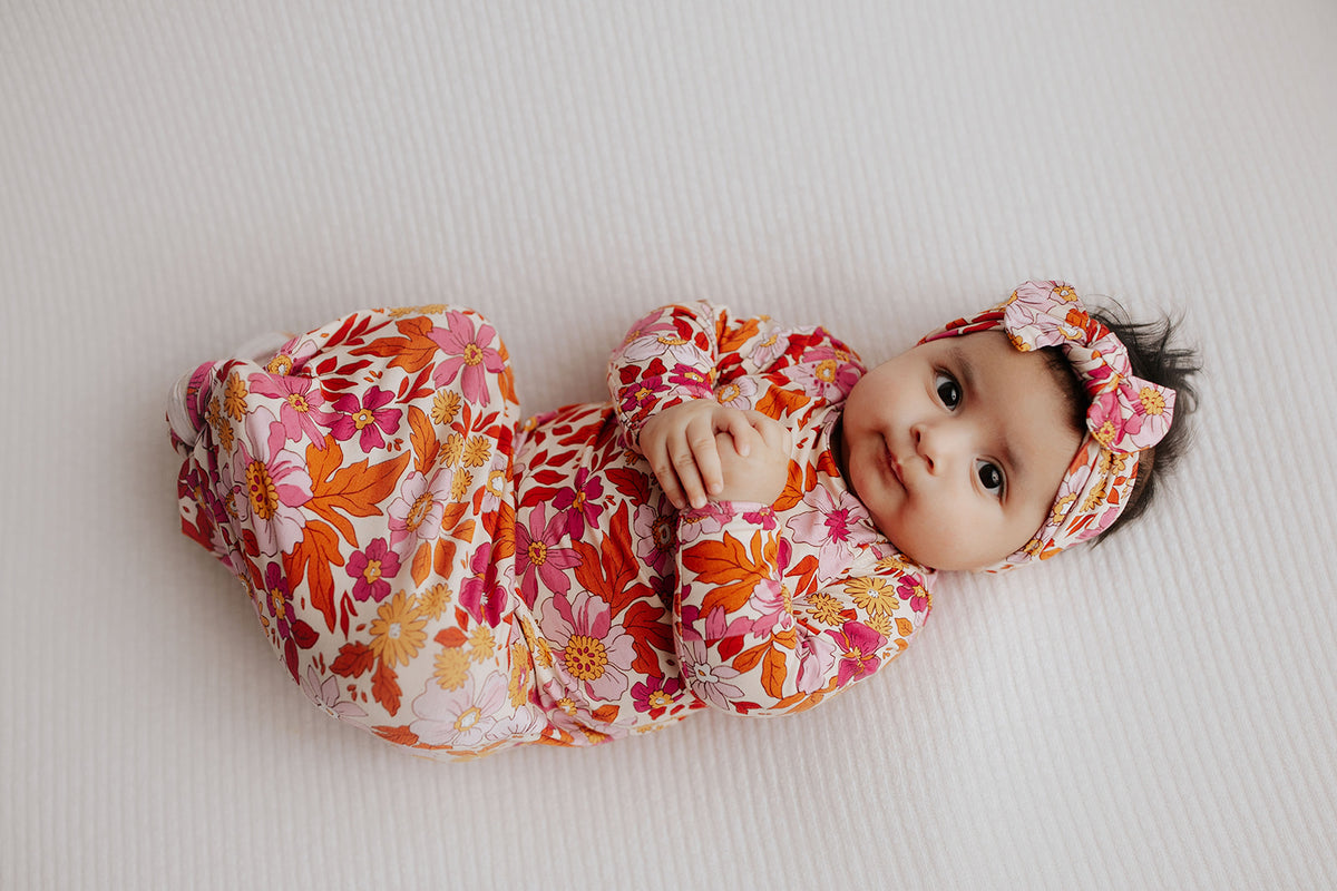 The cutest pink floral design for a newborn knotted baby gown. Trust in our knotted baby gowns, providing unparalleled comfort and ease for your baby's delicate skin.