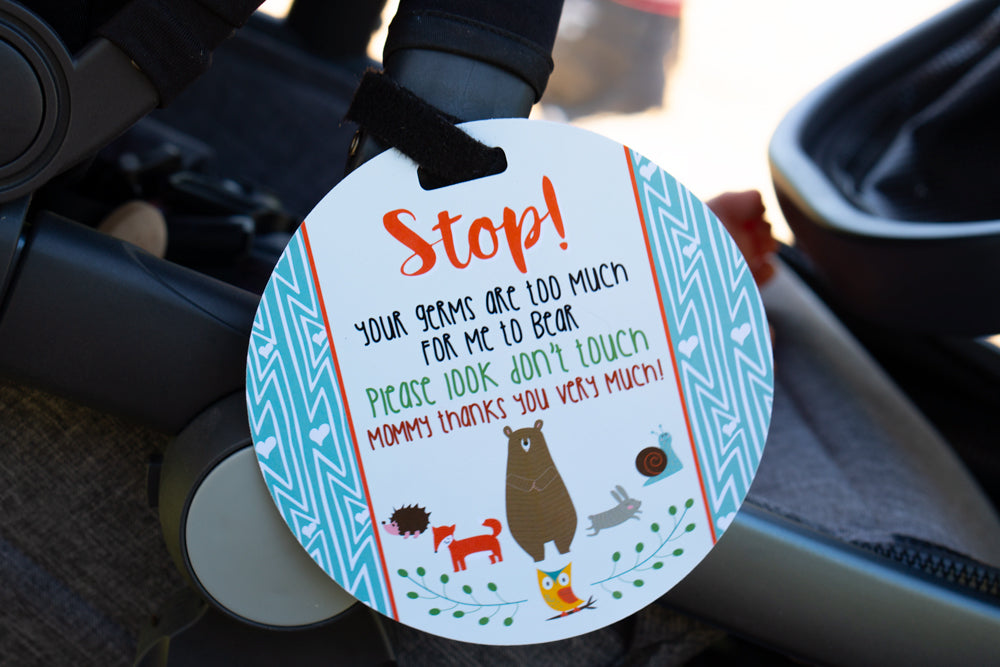 Newborn baby boy woodlands car seat sign to not touch baby on a stroller