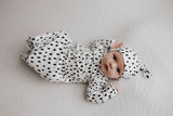 newborn baby in a Three Little Tots polka dot knotted baby gown