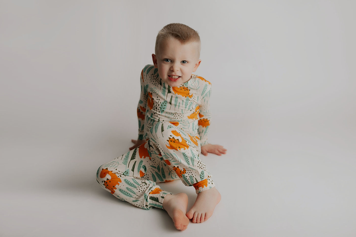 Toddler and big kid jammies in matching prints and solids, designed for comfy bedtime or lounging all day. Dinosaur themed Kids Pajamas.